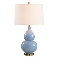 a blue table lamp with a white shade on it