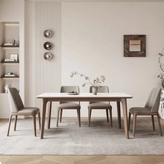 a dining room table and chairs in front of a white wall