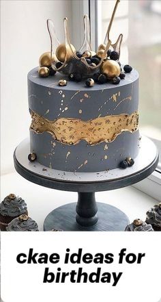 there is a cake that has been decorated with gold and black icing