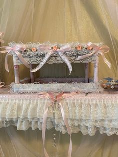 an old fashioned crib decorated with lace and bows