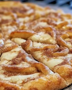 a close up of a pizza on a pan covered in powdered sugar toppings