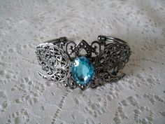 This beautiful silver plated filigree cuff bracelet has a silver plated triple moon design and blue faceted glass setting. Adjustable. Silver Gothic Bangle, Adjustable Mystical Silver Bracelet, Adjustable Silver Mystical Bracelet, Gothic Silver Bracelet, Mystical Silver Jewelry With Intricate Design, Wicca Jewelry, Goddess Bracelet, Triple Moon Goddess, Goddess Jewelry