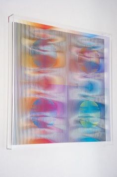 an abstract painting is hanging on the wall in front of a white wall with vertical blinds