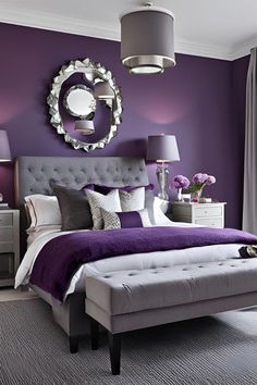 a bedroom with purple walls and white furniture