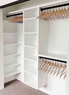 an organized closet with white shelving and wooden hangers on the wall, along with carpeted flooring