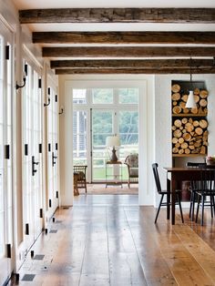 a dining room with wood floors and white walls