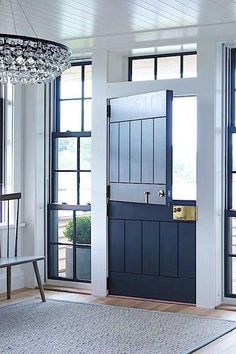 an entryway with blue doors and chandelier