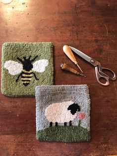 two rugs with sheep on them next to scissors