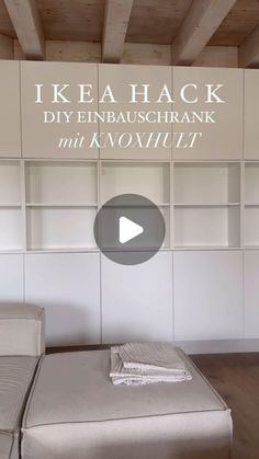 a bed sitting under a wooden ceiling next to a white book shelf filled with books