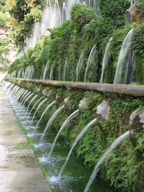 a long row of water cascading down the side of a wall