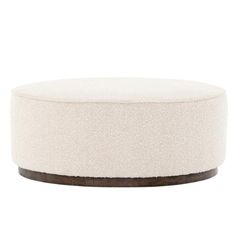 a white round ottoman with wood trim on the top and bottom, in front of a white background