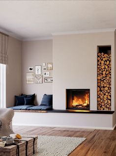 a living room filled with furniture and a fire place next to a wall mounted fireplace