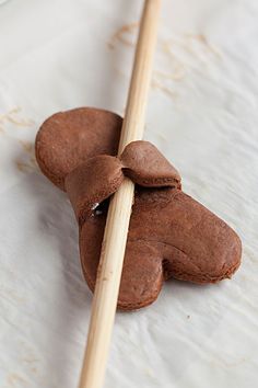 two cookies are tied together with wooden sticks