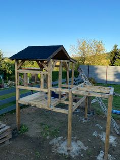 a wooden structure sitting in the middle of a yard