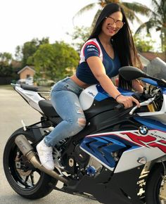 a woman sitting on the back of a motorcycle