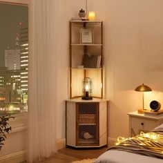 a bed room with a neatly made bed and a night stand next to a window