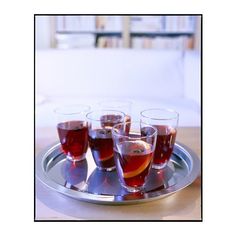 six glasses of wine on a silver tray