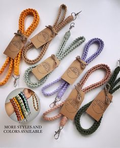 several colors of braided lanyards with tags on them