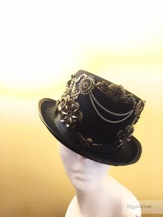 "Neo-Victorian top hat combining a vintage Victorian style with subtle eccentricity of mechanical aesthetic of steampunk, this unisex top hat is fitted with a variety of Victorian vintage baubles and fantastical cogs & gear ornaments on a formed Felt hat with with Ribbon Band. Choosing the custom theme Hat option? Whether you are a high-society aristocrat, a brilliant Steam engineer or a greasy Steam-machine mechanic, your customized hat will work wonderfully with almost any ensemble. S I Z Mechanical Aesthetic, Clown Character, Elegant Face Mask, Victorian Top, Steampunk Hats, Steampunk Hat, Fascinator Hairstyles, Steampunk Wedding, Style Steampunk