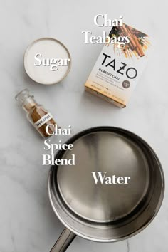 ingredients to make chai spice blend in a saucepan on a marble counter top