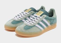 Freshen up your rotation with these men's Gazelle Indoor trainers from adidas Originals. In a Mineral Green colourway with Silver Dawn detailing, these sports-inspired kicks have a soft suede upper for lasting wear. With a classic T-Toe construction, they feature a lace-up fastening with light padding around the collar for a secure fit, and light cushioning underfoot for everyday comfort. They sit atop a retro gum sole with a grippy rubber tread, and are signed off with adidas' legendary 3-Stripes to the sidewalls and the iconic Trefoil logo throughout. | JI0323 Adidas Shoes Women Outfit, Adidas Gazelle Indoor, Adidas Gazelle Green, Cute Converse Shoes, 270 Nike, Cute Converse, Nike Tech, Jd Sports, Girl Problems