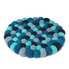 a blue and black round rug on a white background