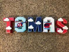 the word tom's spelled in wooden letters