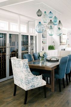 the dining room table is surrounded by blue chairs