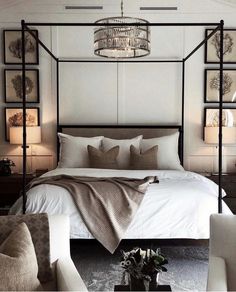 a bedroom with a four poster bed and white furniture