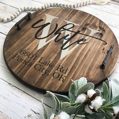 a wooden sign with the words coffee on it next to some cotton flowers and beads