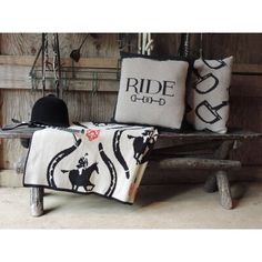 two black and white pillows sitting on top of a wooden bench