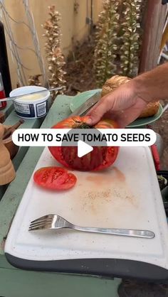 a person cutting up tomatoes on top of a cutting board with a knife and fork