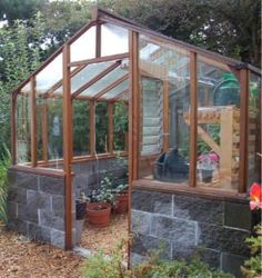 a small greenhouse in the middle of a garden