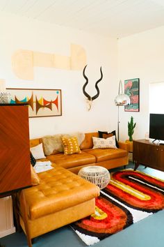 a living room filled with furniture and a flat screen tv