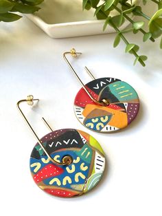 Make a bold statement in these in these unique, contemporary patchwork earrings. Polymer earrings are lightweight and comfortable enough to wear all day. A fun look to have in your jewelry collection. Completely handmade and one of a kind. Materials: Polymer Earring hoop: Gold plated brass Dimensions: Approximately 3" L x 1.75" W Exactly as pictured and ready to ship. Care: Please keep away from oils, lotions, and perfumes. Do not wear in water. Take care when handling these pieces: they are built sturdily with the highest quality clay, but clay is not unbreakable. The colors displayed may be slightly different due to your monitor's color calibration and resolution settings. Every attempt has been made to represent the product and features as accurately as possible. Thank you for shopping Wearable Art Jewelry, Big Hoop Earrings, Geometric Circle, Polymer Earrings, Black Pattern, Color Calibration, Boho Outfits, Amazing Jewelry, Jewelry Art