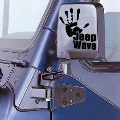 a jeep with the word jeep wave painted on it's side mirror and hand print