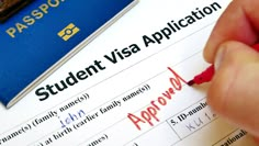 a student visa application with a red pen