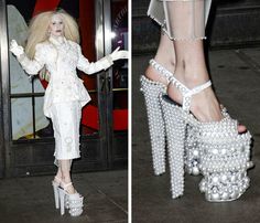 a woman in white high heels with pearls on her feet and an image of a barbie doll