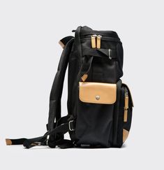 a black and tan backpack with two straps