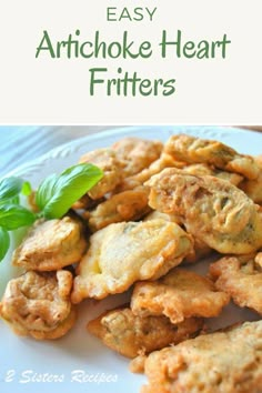 fried artichoke heart fritters on a white plate with basil sprigs