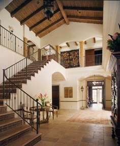 the inside of a house with stairs and railings