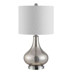 a silver table lamp with a white shade