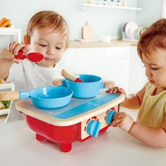 two young children are playing with their toys