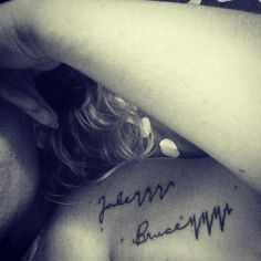 the back of a woman's shoulder with writing on it