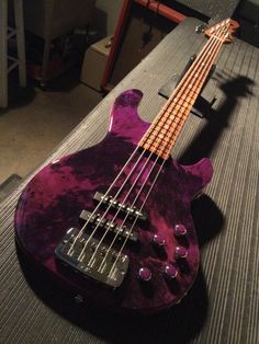 a purple guitar sitting on top of a table