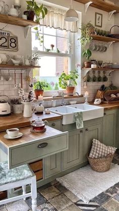 a kitchen filled with lots of pots and pans next to a sink under a window