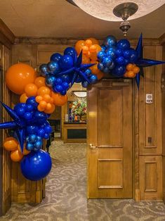 an entrance decorated with blue and orange balloons