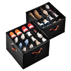 two black boxes filled with pairs of shoes