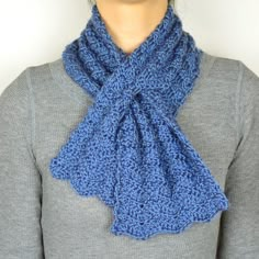 a woman wearing a blue knitted scarf