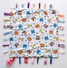 a baby's crib made out of colorful hair clips and fabric with animals on them